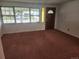 Bright living room featuring a decorative front door and large windows at 6961 E Arkansas Ave, Denver, CO 80224