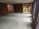 Open living room with brick accent wall and adjacent kitchen at 6961 E Arkansas Ave, Denver, CO 80224