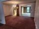 Open-concept living and dining area with an antique grandfather clock at 6961 E Arkansas Ave, Denver, CO 80224