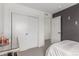 The bedroom has a modern gray wall and a closet as well as a small amount of wall decorations at 21451 E 60Th Ave, Aurora, CO 80019
