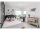 This bedroom has a mirrored dresser and a bedside table, as well as views through the windows at 21451 E 60Th Ave, Aurora, CO 80019