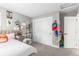 Bedroom includes a closet, a gray rug, and a small desk with an transparent chair at 21451 E 60Th Ave, Aurora, CO 80019