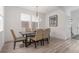 Bright dining area with a modern chandelier, table that seats six, and neutral color palette at 21451 E 60Th Ave, Aurora, CO 80019