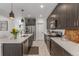 Sleek kitchen featuring stainless steel appliances, a spacious island, and elegant white countertops at 21451 E 60Th Ave, Aurora, CO 80019