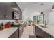 Modern kitchen with stainless steel appliances, quartz countertops, and open layout to the living room at 21451 E 60Th Ave, Aurora, CO 80019