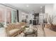 Inviting living space with patio access, open to the kitchen, featuring comfortable seating and stylish decor at 21451 E 60Th Ave, Aurora, CO 80019