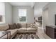 Comfortable living area with a large window, neutral-toned sofa, and stylish geometric rug at 21451 E 60Th Ave, Aurora, CO 80019
