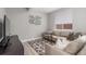 Relaxing living room with a sectional sofa, modern decor, and ample seating for entertaining guests at 21451 E 60Th Ave, Aurora, CO 80019