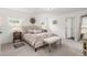 Bright, carpeted main bedroom with a decorative ceiling fan and a large bed with an upholstered headboard at 21451 E 60Th Ave, Aurora, CO 80019
