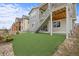 Well-maintained backyard with artificial turf and access staircase to the upper level at 9021 Swan River St, Littleton, CO 80125
