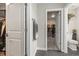 Bathroom with toilet and access to walk in closet, doors and towels at 9021 Swan River St, Littleton, CO 80125