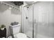 Well-lit bathroom with toilet and glass-enclosed shower at 9021 Swan River St, Littleton, CO 80125
