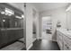 Bright bathroom leads to the bedroom and has a tiled shower and double vanity at 9021 Swan River St, Littleton, CO 80125