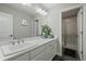 Bathroom has double vanity with plants and shower at 9021 Swan River St, Littleton, CO 80125