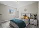 Cozy bedroom featuring a bed, nightstand, window, and neutral decor at 9021 Swan River St, Littleton, CO 80125