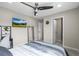 Cozy bedroom features a ceiling fan, TV, mirror, and neutral decor at 9021 Swan River St, Littleton, CO 80125