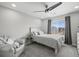 Bright, airy bedroom with a large bed, ceiling fan, and view of the neighborhood at 9021 Swan River St, Littleton, CO 80125
