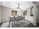 Bright dining room featuring modern lighting, tray ceiling, and space for entertaining at 9021 Swan River St, Littleton, CO 80125