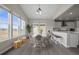 Bright dining area with large windows, vaulted ceilings, and easy access to kitchen and living areas at 9021 Swan River St, Littleton, CO 80125