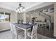 Bright dining room featuring modern lighting, with staircase and interior views at 9021 Swan River St, Littleton, CO 80125