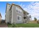 Exterior view of a two-story home with a backyard, stairs to deck, and meticulous landscaping at 9021 Swan River St, Littleton, CO 80125