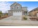 Charming two-story home with a two car garage and landscaped front yard at 9021 Swan River St, Littleton, CO 80125