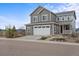 Charming two-story home with a two car garage and landscaped front yard at 9021 Swan River St, Littleton, CO 80125
