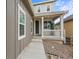 Charming covered front porch with white columns and well maintained landscaping at 9021 Swan River St, Littleton, CO 80125