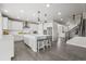 Bright, open kitchen with white cabinets, stainless steel appliances, and a large center island with seating at 9021 Swan River St, Littleton, CO 80125