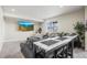 Modern living room with a large sectional, TV, and a unique bar table at 9021 Swan River St, Littleton, CO 80125