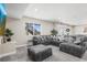Spacious living room with a comfy sectional, large TV, and natural light at 9021 Swan River St, Littleton, CO 80125