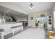 Open-concept living space featuring access to kitchen, stairs, and outdoor patio at 9021 Swan River St, Littleton, CO 80125