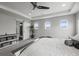 Bright main bedroom features a tray ceiling, ample natural light, and comfortable furnishings at 9021 Swan River St, Littleton, CO 80125