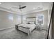 Elegant main bedroom featuring a tray ceiling, plush carpeting, and bright windows at 9021 Swan River St, Littleton, CO 80125