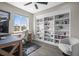 Home office featuring built-in bookshelves and a large window for natural light at 9021 Swan River St, Littleton, CO 80125