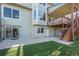 The backyard boasts well-kept artificial grass, a patio, and stairs to the deck at 853 Huntington Dr, Highlands Ranch, CO 80126