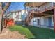 The backyard features a shed, artificial grass, and stairs to the deck at 853 Huntington Dr, Highlands Ranch, CO 80126