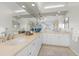 Bright bathroom featuring double sinks, vanity, and neutral countertops at 853 Huntington Dr, Highlands Ranch, CO 80126
