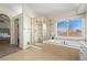 Bright bathroom featuring a glass enclosed shower, soaking tub, and large window at 853 Huntington Dr, Highlands Ranch, CO 80126