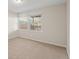 A bright bedroom with two large windows and neutral carpeting at 853 Huntington Dr, Highlands Ranch, CO 80126