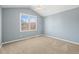 A bedroom with blue walls, carpet flooring, a ceiling fan, and a window view at 853 Huntington Dr, Highlands Ranch, CO 80126