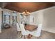 Open dining room featuring tray ceiling, chandelier, and seamless flow into living spaces at 853 Huntington Dr, Highlands Ranch, CO 80126