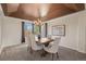 Elegant dining room featuring a tray ceiling, chandelier, and a view of the backyard at 853 Huntington Dr, Highlands Ranch, CO 80126