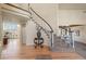Spacious foyer featuring a curved staircase, hardwood floors, and an elegant entryway table at 853 Huntington Dr, Highlands Ranch, CO 80126