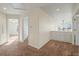 A bright hallway with carpet floors, connecting rooms, and featuring a view from an open space at 853 Huntington Dr, Highlands Ranch, CO 80126