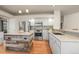 Modern kitchen featuring stainless steel appliances, granite countertops, an island with a wood accent, and light cabinets at 853 Huntington Dr, Highlands Ranch, CO 80126