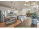 Open-concept kitchen with stainless appliances, a wood-accented island, adjacent dining and access to living room with a fireplace at 853 Huntington Dr, Highlands Ranch, CO 80126