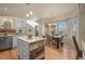 Bright kitchen with natural light, featuring a dining area with large windows, and an island with wood accents at 853 Huntington Dr, Highlands Ranch, CO 80126