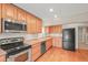 The kitchen features stainless steel appliances and abundant wooden cabinets at 853 Huntington Dr, Highlands Ranch, CO 80126