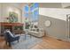 Bright living room featuring a fireplace, hardwood floors, and large windows allowing for natural light at 853 Huntington Dr, Highlands Ranch, CO 80126